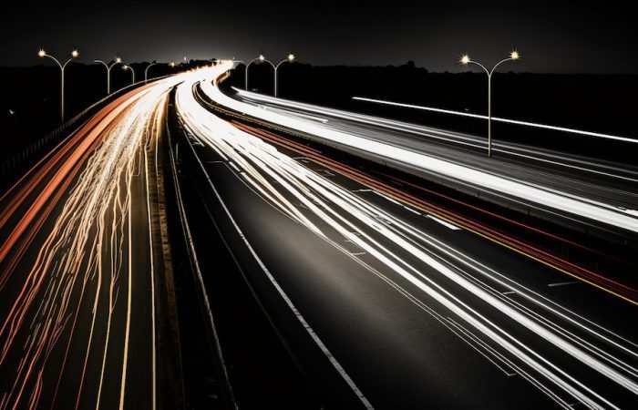 Road at night seeing only stripes of head and tail lights as shutter of the camera was increased
