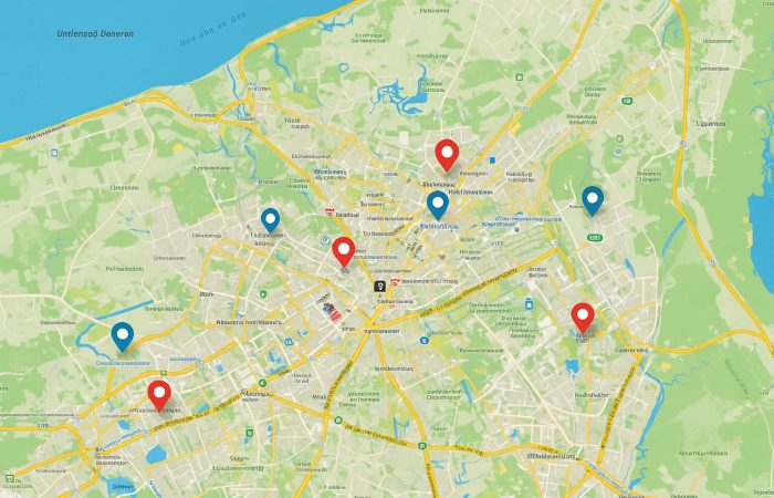 A digital map displaying several red and blue location markers across the city, showcasing the potential of community-powered maps for visualizing user-contributed points of interest and navigation data.